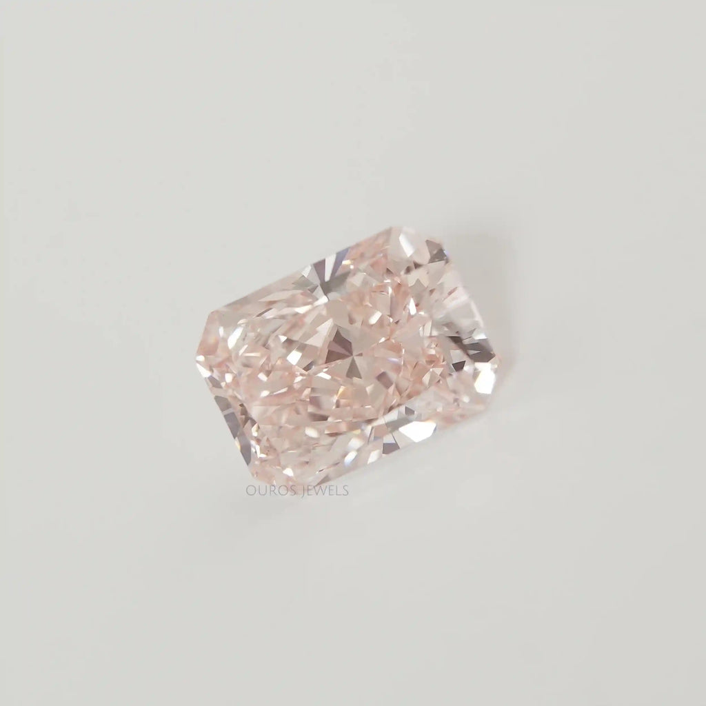 Radiant Cut Pink Diamond on White Surface 