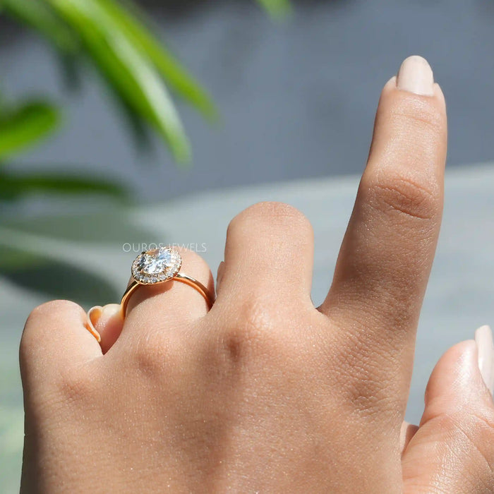 [ a women wearing oval halo lab diamond engagement ring]-[Ouros Jewels]
