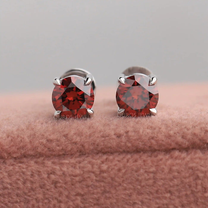 A pair of Red Round Cut Eco Friendly Diamond Stud Earrings