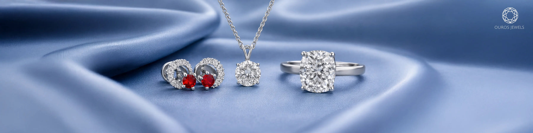 Ouros Jewels lab grown diamond jewelry set featuring ruby halo stud earrings, round diamond solitaire pendant necklace, and cushion cut diamond solitaire engagement ring