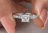 White gold princess diamond engagement ring made with shared surface prong settings.