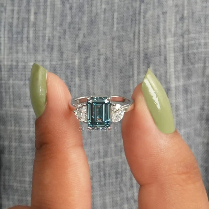 [A Women wearing Blue Diamond Emerald Cut Engagement Ring]-[Ouros Jewels]