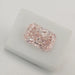 Certified Pink Diamond on White Surface 