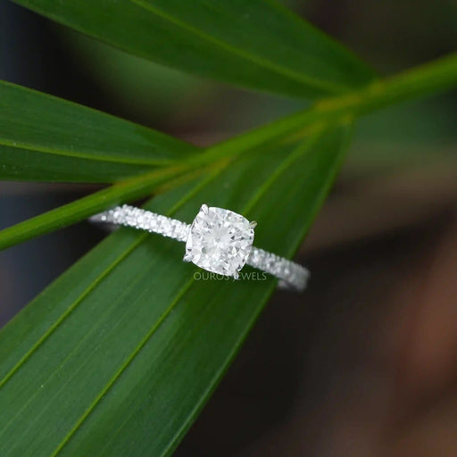 [a white diamond cushion-cut ring on top of a leaf]-[Ouros Jewels]