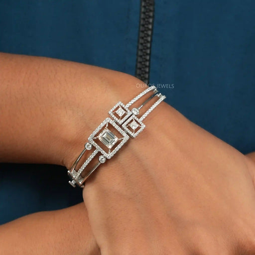 [A Women wearing unique emrald and princess cut bangle]-[Ouros Jewels]