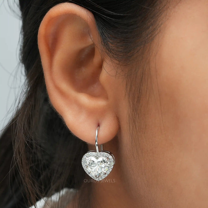 [a close up of a woman's ear with a heart shaped earring]-[Ouros Jewels]