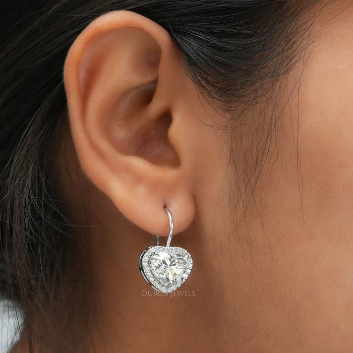 [a women wearing heart diamond earrings]-[Ouros Jewels]