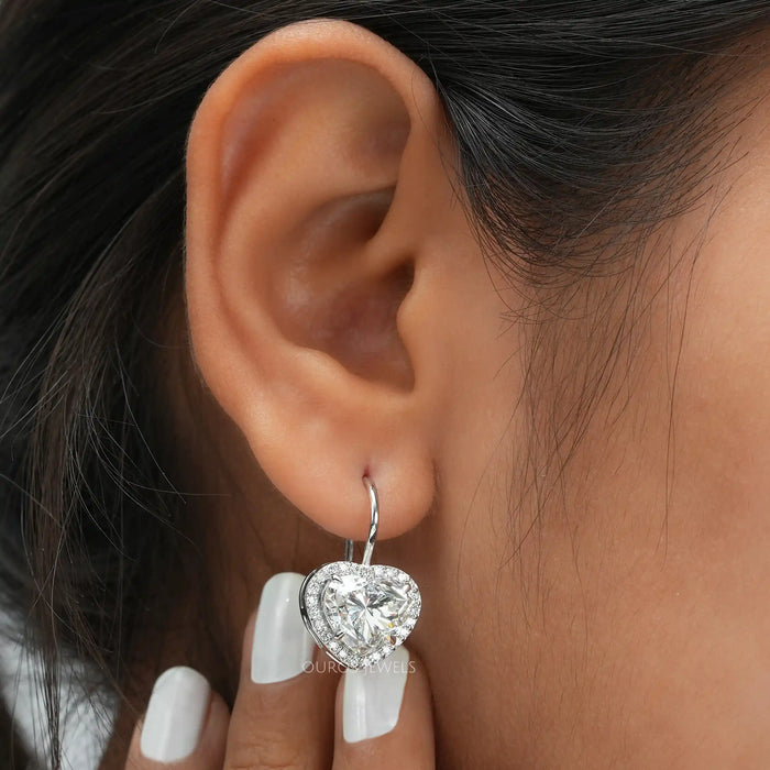 [a woman's ear with a diamond heart shaped earring]-[Ouros Jewels]