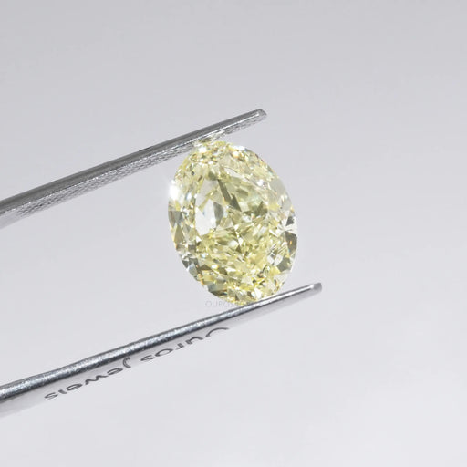 Yellow Oval Cut Diamond in a Tweezer 