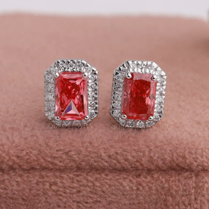 A pair of fancy pink radiant cut diamond stud earrings