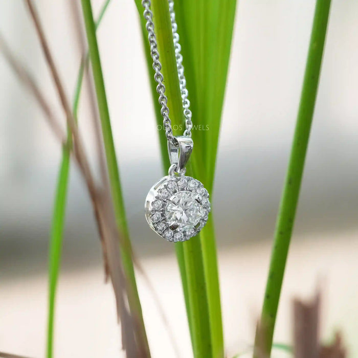 [a round diamond pendant hanging from a stem of tall grass]-[Ouros Jewels]