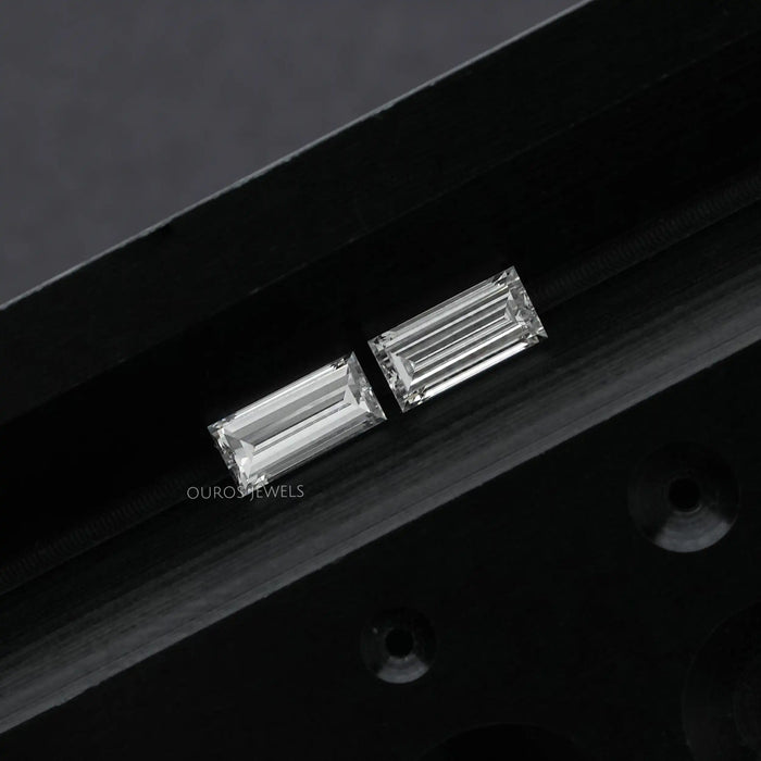 [a pair of baugette shaped lab grown diamond on black surface]-[Ouros Jewels]