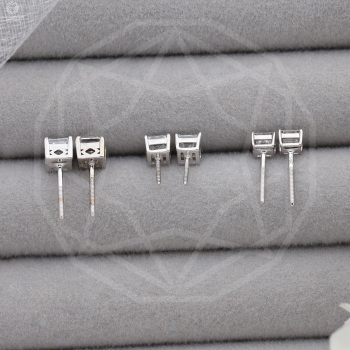 [the group of diamond earrings in princess cut on grey surface]-[Ouros Jewels]