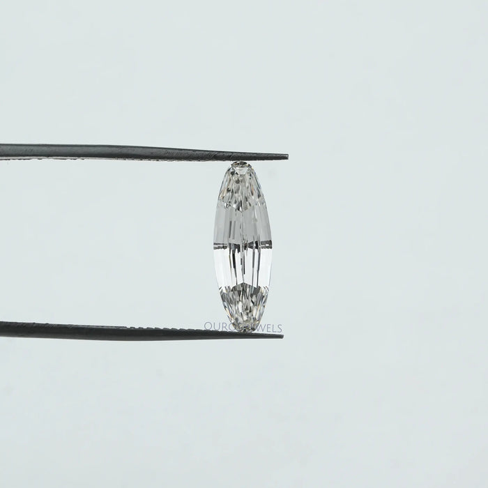 [a oval diamond is being put under a pair of tweezers]-[Ouros Jewels]