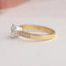 Round accent stone studded on 14k yellow gold shank of OEC round diamond engagement ring