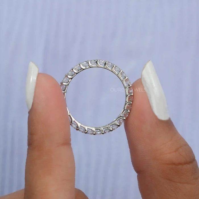 [A Women Holding Round Diamond Eternity Ring]-[Ouros Jewels]