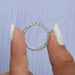 [A Women Holding Round Diamond Eternity Ring]-[Ouros Jewels]
