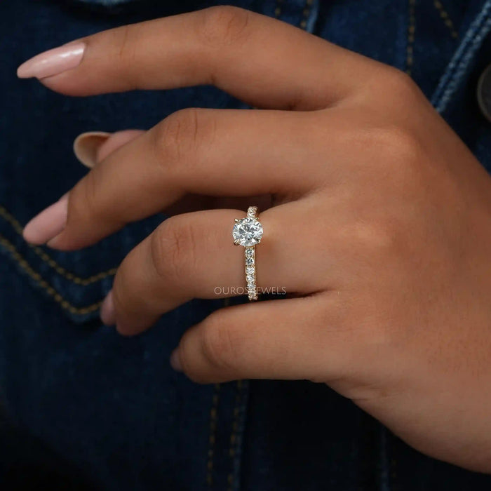 [a woman's hand holding a round accent diamond ring]-[Ouros Jewels]