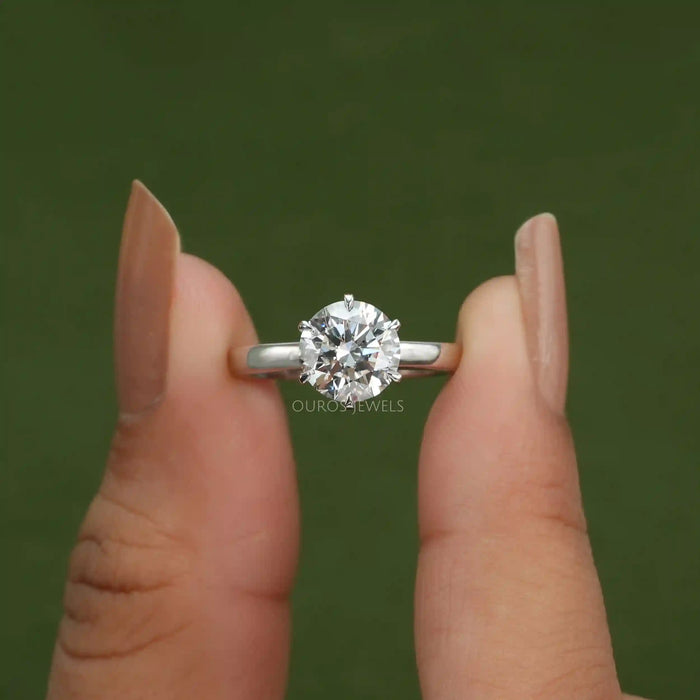 [A Women holding Round Diamond Solitaire Ring]-[Ouros Jewels]
