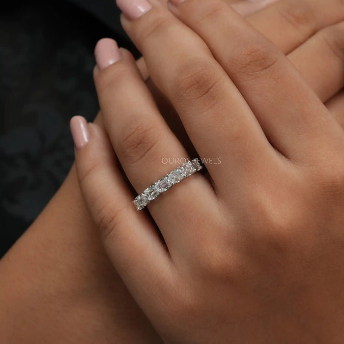 [A Women wearing seven diamond emerald cut ring]-[Ouros Jewels]