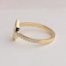 Round stone studded on 14k yellow gold shank of moval diamond engagement ring