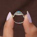 A close up fancy blue heart diamond infinity symbol wedding ring