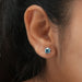 In ear look shining fancy blue lab grown diamond stud earrings secured with four claw prongs