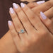 In finger front look of pear and round diamond anniversary ring