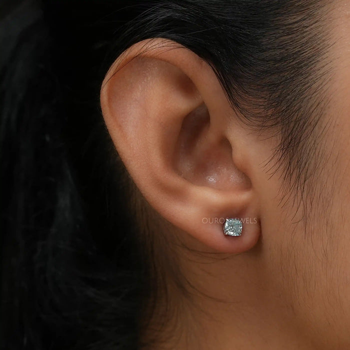 In ear look of blue cushion lab created diamond solitaire earrings