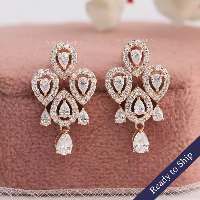 Flower shaped lab grown diamond earrings with pear shaped diamonds in halo setting made in 14k rose gold