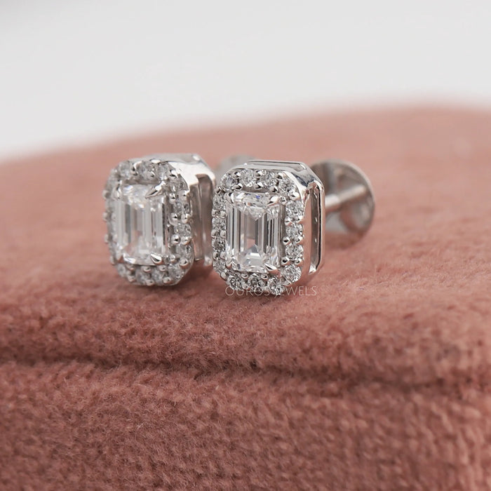 Stunning stud earrings set in emerald cut diamonds with halo setting.