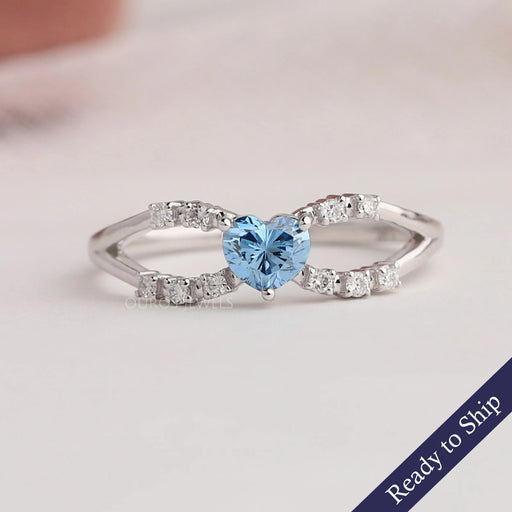 Blue heart lab grown diamond infinity ring with spilt shank and round accent stones
