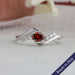 Red oval shaped lab grown diamond dainty wedding ring with a exceptional bypass setting