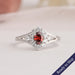 Red oval brilliant cut lab grown diamond engagement ring with a sparkling halo of round diamonds 