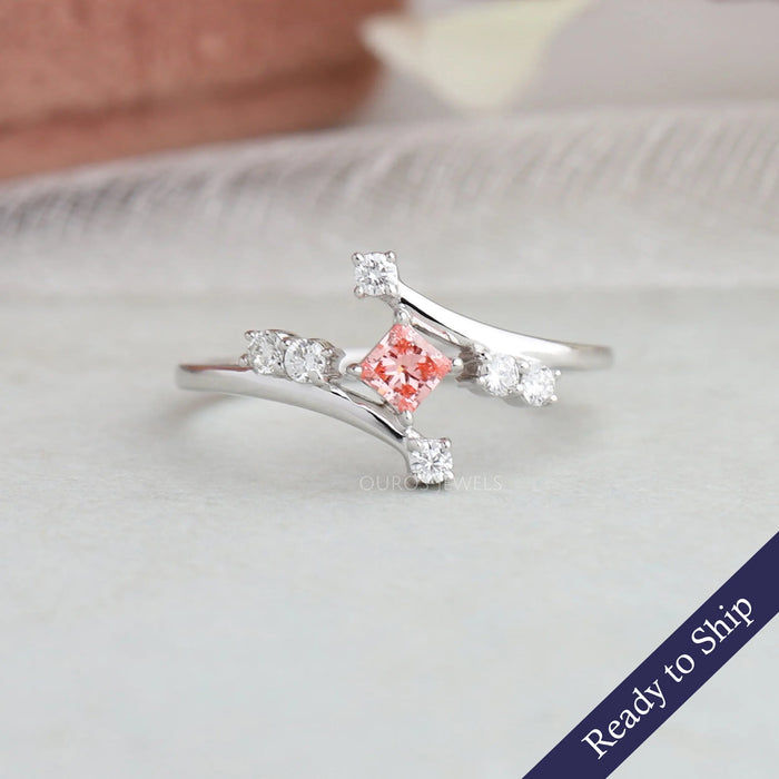 Pink cut lab grown diamond bypass engagement ring with round accent stones in 14k white gold