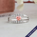 Pink heart shaped diamond engagement ring with three row split shank studded with round accent stones in 14k white gold