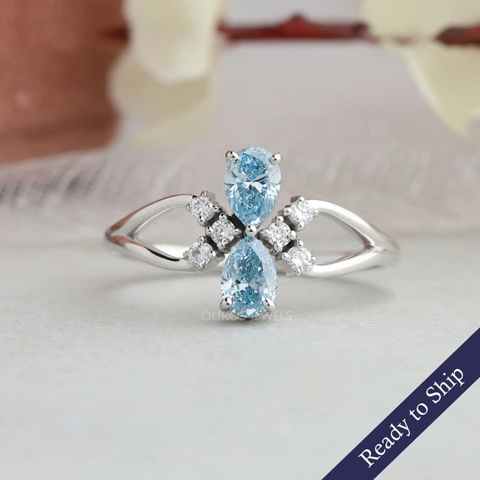 Blue pear shaped lab grown diamond 2 stone dainty engagement ring made with round accents on split shank of 14k white gold