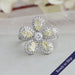 Floral style yellow pear lab grown diamond engagement ring with sparkling halo of round diamonds in 14k white gold