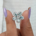Unique flower shaped lab manufactured diamond engagement ring with light blue pear shaped diamonds