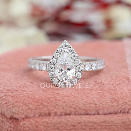 Pear brilliant cut solitaire diamond engagement ring with a lovely halo setting and accent stones in solid white gold