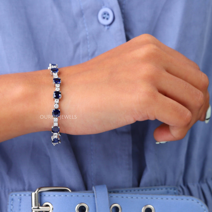 [A Women wearing Natural Blue Sapphire Cushion Tennis Bracelet]-[Ouros Jewels]
