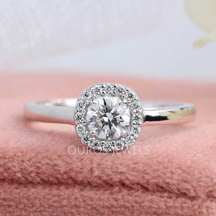 Round cut solitaire diamond engagement ring in a lovely halo setting with VVS clarity diamonds in solid gold