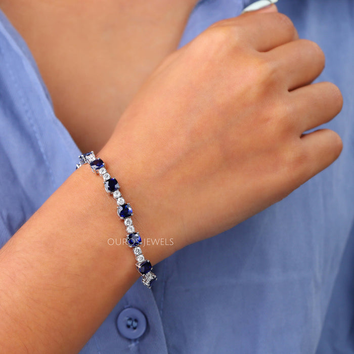 [A Women wearing Blue Sapphire Tennis Bracelet]-[Ouros Jewels]
