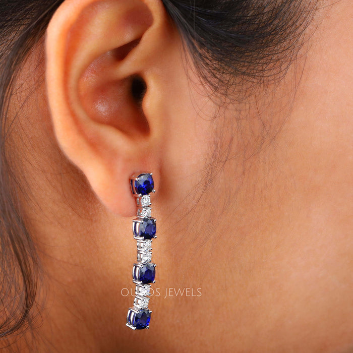[A Women wearing Blue Sapphire Diamond Earrings]-[Ouros Jewels]