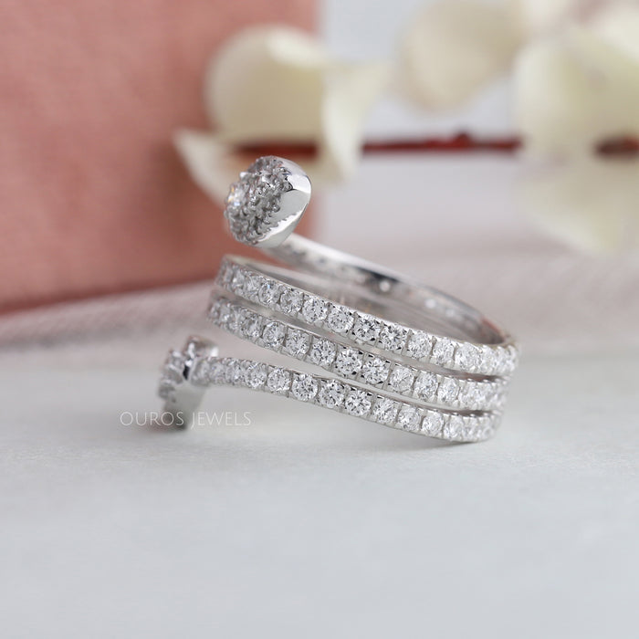Side view of Round Diamond Cluster Ring set in bypass & side small round cut diamonds.
