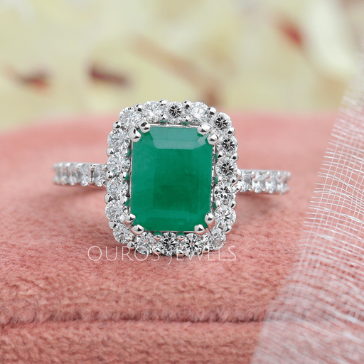 Natural green emerald cut gemstone engagement ring with halo setting in solid white gold