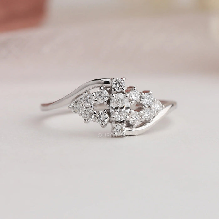 Cluster setting of oval cut diamond ring in white gold