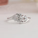 Cluster setting of oval cut diamond ring in white gold
