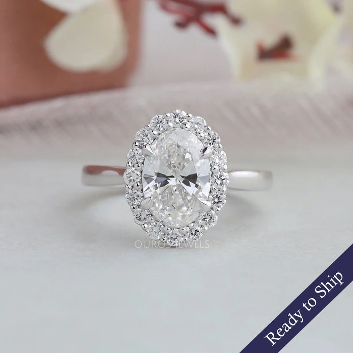 1.5 carat oval cut lab grown diamond engagement ring with halo of round diamonds in 14k white gold
