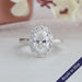 1.5 carat oval cut lab grown diamond engagement ring with halo of round diamonds in 14k white gold
